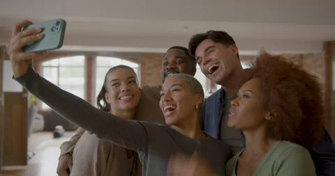 Group of friends taking a selfie in a loft apartment Stock Footage 252837059