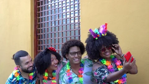Group of friends taking a selfie while celebrating the carnival Видео 229700494