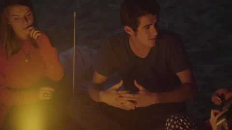 Group of friends talk by the fire Stock Footage 54032983