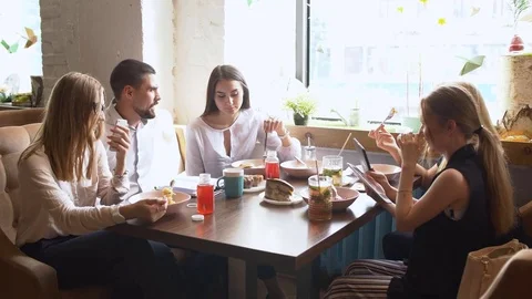 Group of friends talking about work while they eating. Video stock 77543052