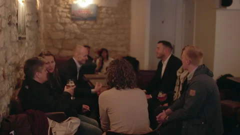 Group Of Friends Talking And Drinking Beer In Pub 스톡 동영상 344374887