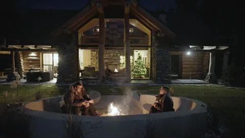 Group of friends talking and hanging out around the outdoor fire pit  Stock Footage 196306194