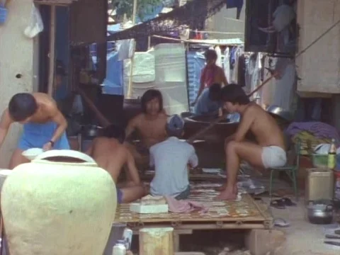 Group of friends talking and working in hut Stock Footage 79880582