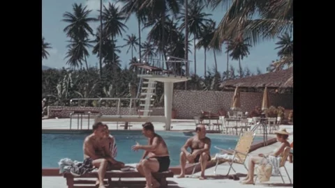 Group of friends talking by a swimming pool in the 1950s Stock Footage 346215711