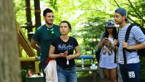 Group of friends talking in the woods Video stock 94499524