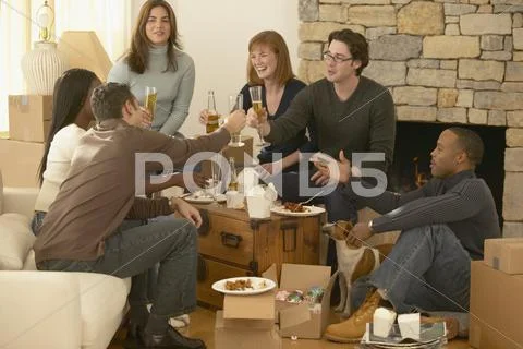 Group Of Friends Toasting Over Take Out Food