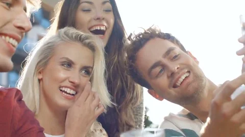 Group of friends using phone during sunny day. 動画素材 69104066