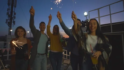 A group of friends waving sparklers. Stock Footage 112579256