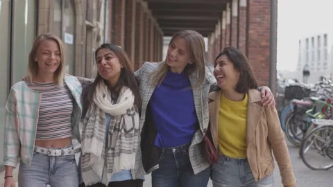 Group of friends young cheerful women walking embraced together on the city s Stock Footage