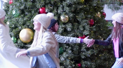 Group Of Fun Teens Dance In Front Of Christmas Tree In Mall Video stock 54804785