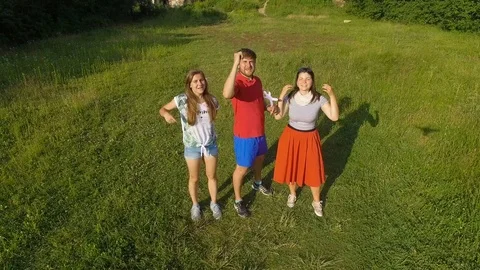 Group Of Fun Teens Take Aerial Selfies, Smile And Make Faces Stock Footage 77972826