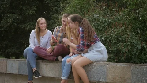 Group of funny teenagers using mobile phones outdoors Stock Footage 74561297