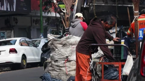 Group of garbage men collecting garbage in Mexico city. Stock Footage 228080130