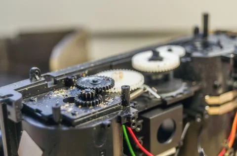 A group of gears of a compact camera to be repaired. Cleaning the gears inside Stock Photos