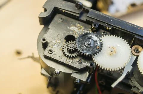 A group of gears of a compact camera to be repaired. Cleaning the gears inside Stock Photos