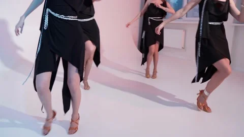 A group of girls are dancing in the studio in black dresses. Hand-held video Stock Footage 152920358