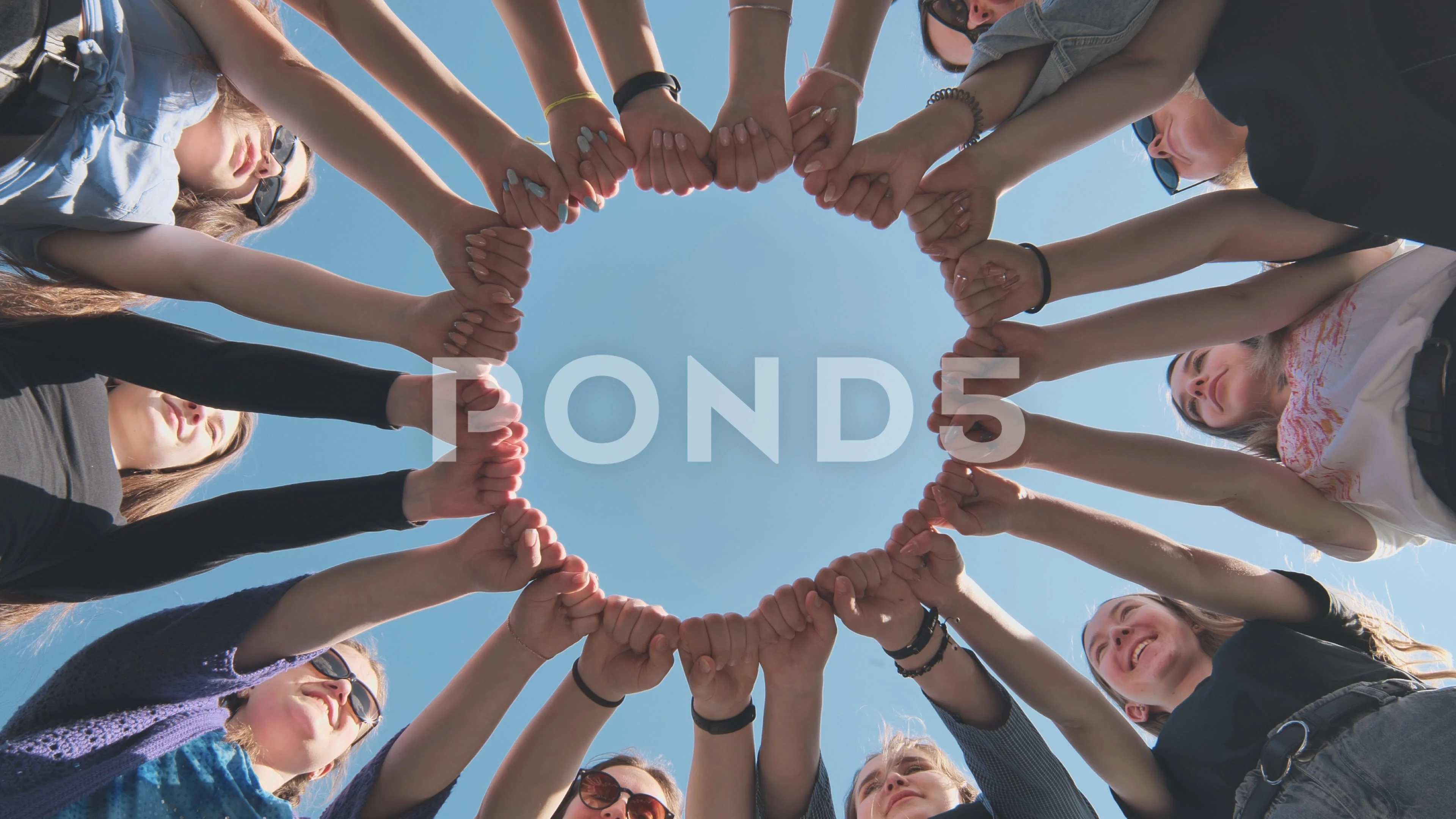 people holding hands in a circle