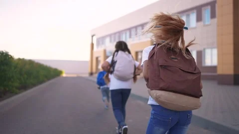 A group of girls running back to school. Bag elementary happy concept. Children Stock Footage 316611342