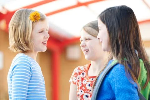 Group Of Girls Talking Outside School Building Stock Photos
