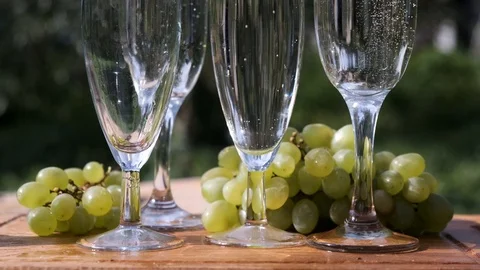 Group glasses with sparkling champaign with bubbles with grape. Stock Footage 114637598