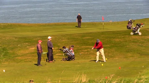 A group of golf player golfing over the sea Stock Footage 37252489