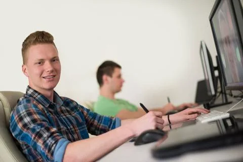A group of graphic designers at work a group of young graphic designers wo... Stock Photos