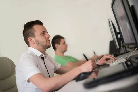 A group of graphic designers at work a group of young graphic designers wo... Stock Photos