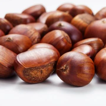 Group of grilled chestnuts. Isolate on white background. Stock Photos
