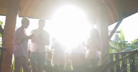 Group Of Group Using Cell Smart Phones On Summer Terrace In Morning Messaging In Stock Footage