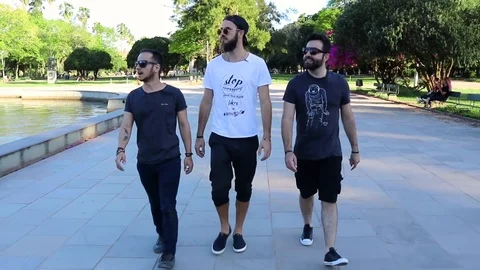 Group of Guys Walking in Slow Motion on a Park in a Sunny Day Front View Vídeo Stock 97027410