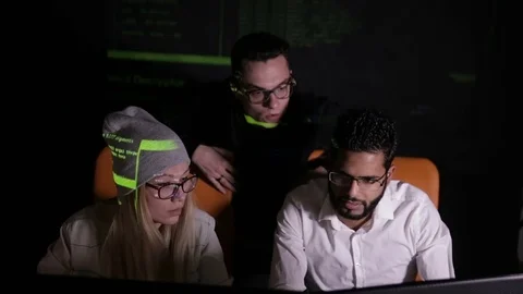 Group of hacker using computer code in dark Stock Footage 69794798