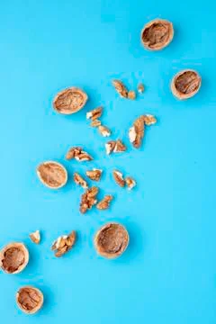 Group of halves of walnut on blue background Stock Photos