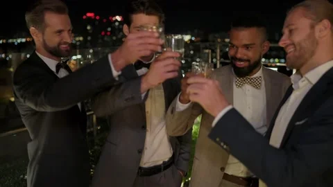 Group of handsome young men in suits spending time on rooftop party Stock Footage 160836399