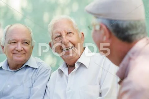 Group of happy elderly men laughing and talking Stock Photos