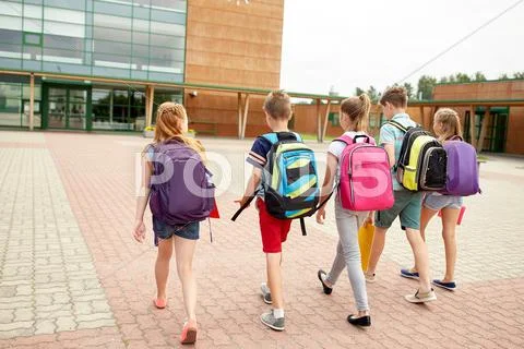 Group of happy elementary school students walking Stock Photos