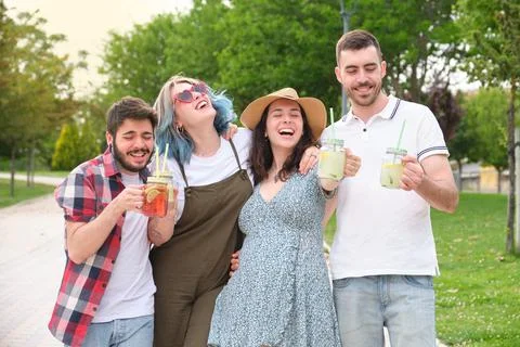 Group of happy friends drinking refreshing drinks and having fun Stock Photos