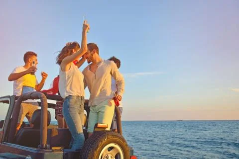 Group of happy friends making party in car - Young people having fun drinking Stock Photos
