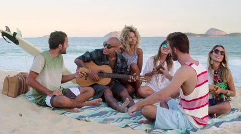 Group of happy friends playing guitar and singing on Ipanema beach Stock Footage 59377946
