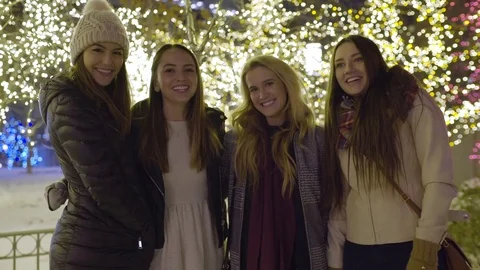 Group Of Happy Friends Pose In Front Of Christmas Light Display Downtown Video stock 73244822
