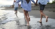 Group Of Happy Friends Running On The Beach At Summer At Sunset Stock Footage
