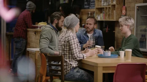Group of happy friends talking to each other and spending time at cafe Stock Footage 108047189