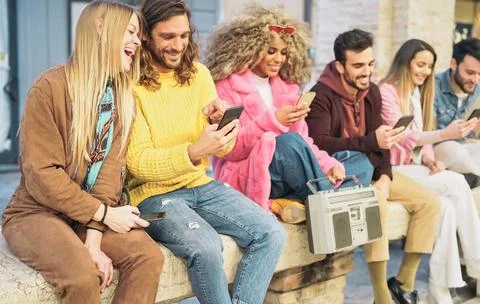 Group happy friends using mobile smartphones in the city Stock Photos