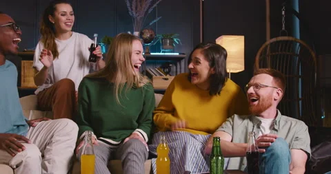 Group of happy fun multiethnic young friends talk, laugh cheerfully sitting on Video stock 171973606