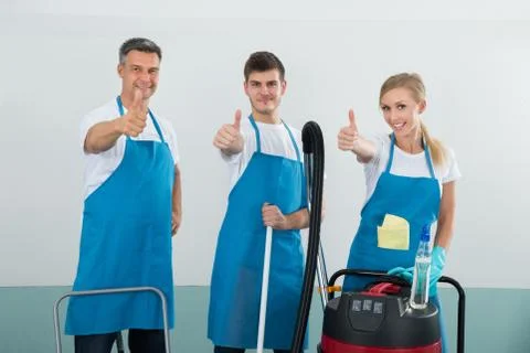 Group Of Happy Janitors With Cleaning Equipments Showing Thumb Up Sign Stock Photos