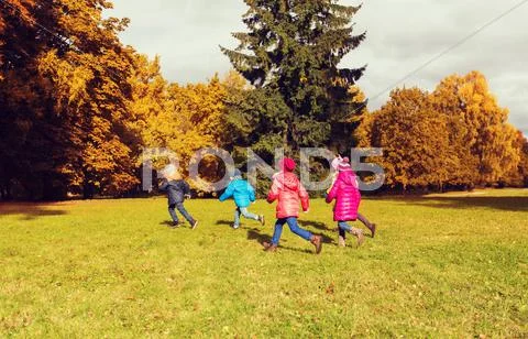 Group of happy little kids running outdoors Stock Photos