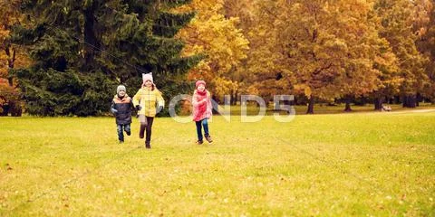 Group of happy little kids running outdoors Stock Photos