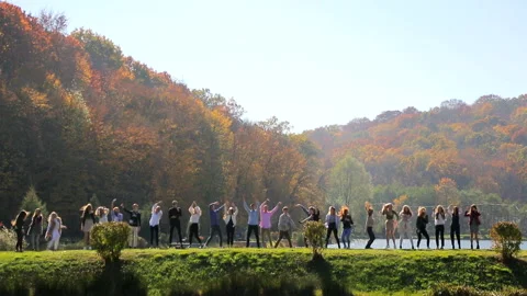 A group of happy people dancing in the park near the lake. Stock Footage 101550271