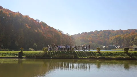 A group of happy people dancing in the park near the lake. Stock Footage 101630786