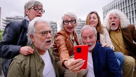 Group happy senior people using mobile phone together outdoor. Elderly friends Stock Footage 274841075
