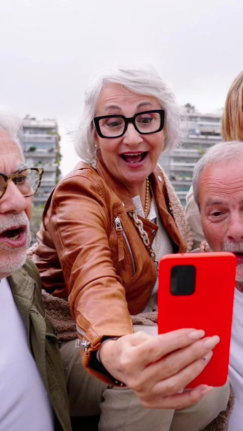 Group happy senior people using mobile phone together outdoor. Elderly friends Stock Footage 276193999